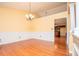 Dining room with hardwood floors and wainscoting, offering a seamless transition to the kitchen at 1015 Buckeye Ln, Villa Rica, GA 30180