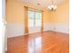 Hardwood floors, chair rail, and natural light grace this inviting dining room at 1015 Buckeye Ln, Villa Rica, GA 30180