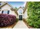 Elegant entryway with beautiful landscaping, complemented by a modern glass door at 1015 Buckeye Ln, Villa Rica, GA 30180