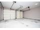 Spacious two-car garage with freshly painted walls and dual overhead doors, offering ample parking and storage solutions at 1015 Buckeye Ln, Villa Rica, GA 30180