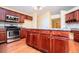 Kitchen featuring stainless steel oven and microwave, granite countertops, and cherry cabinets at 1015 Buckeye Ln, Villa Rica, GA 30180