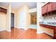 Kitchen features cherry cabinets and desk area, with a view to other rooms at 1015 Buckeye Ln, Villa Rica, GA 30180