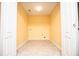 Bright yellow laundry room with white trim and tile floors at 1015 Buckeye Ln, Villa Rica, GA 30180