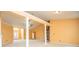 Spacious living room featuring decorative columns, a ceiling fan, and neutral carpeting at 1015 Buckeye Ln, Villa Rica, GA 30180
