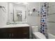 Bright bathroom featuring a modern vanity with blue tile backsplash, toilet, and bathtub with colorful shower curtain at 1384 N Crossing Ne Dr, Atlanta, GA 30329