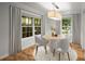 Charming dining room with a round table, modern lighting, and bright windows at 1384 N Crossing Ne Dr, Atlanta, GA 30329