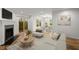 Bright living room with a fireplace, wood floors, and large windows overlooking backyard at 1384 N Crossing Ne Dr, Atlanta, GA 30329
