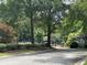 Street view of community amenities including a community pool and tennis court, surrounded by lush landscaping at 1384 N Crossing Ne Dr, Atlanta, GA 30329