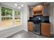Stylish wet bar area featuring a wine cooler, wooden cabinets, and natural light at 1384 N Crossing Ne Dr, Atlanta, GA 30329
