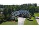 Spacious home with dormer windows, mature landscaping, and a long, curved driveway at 154 Gold Leaf Trail Trl, Powder Springs, GA 30127