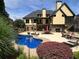Expansive backyard featuring a large pool, patio, and lush landscaping at 154 Gold Leaf Trail Trl, Powder Springs, GA 30127
