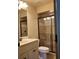 Updated bathroom with tiled shower and glass door, modern vanity and toilet at 154 Gold Leaf Trail Trl, Powder Springs, GA 30127
