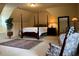 Bedroom with four-poster bed, dark wood furniture, oriental rug, and vaulted ceilings at 154 Gold Leaf Trail Trl, Powder Springs, GA 30127