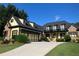Charming two-story home with a well-maintained lawn, three-car garage, and inviting entryway at 154 Gold Leaf Trail Trl, Powder Springs, GA 30127