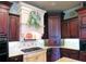 Beautiful kitchen with decorative range hood, granite countertops, wood cabinetry, and stainless appliances at 154 Gold Leaf Trail Trl, Powder Springs, GA 30127