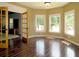 Bright sunroom with hardwood floors and multiple windows offering backyard and pool views at 154 Gold Leaf Trail Trl, Powder Springs, GA 30127