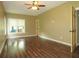 Light-filled living room with wood floors, large window and open doorway at 154 Gold Leaf Trail Trl, Powder Springs, GA 30127