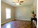 Spacious living room with gleaming hardwood floors, large window, and elegant console table at 154 Gold Leaf Trail Trl, Powder Springs, GA 30127
