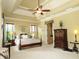 Spacious main bedroom features a tray ceiling, a comfortable bed, and complementary furnishings at 154 Gold Leaf Trail Trl, Powder Springs, GA 30127