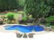 Inviting backyard pool with waterfall feature, surrounded by beautifully landscaped gardens at 154 Gold Leaf Trail Trl, Powder Springs, GA 30127