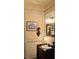 Stylish powder room featuring decorative molding, elegant fixtures, and charming accents at 154 Gold Leaf Trail Trl, Powder Springs, GA 30127