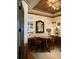 Cozy sitting area with hardwood floors, wooden tray ceiling, round table, and comfortable chairs at 154 Gold Leaf Trail Trl, Powder Springs, GA 30127