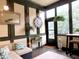 Inviting sun room featuring paneled walls, pendant lighting, and views of nature at 154 Gold Leaf Trail Trl, Powder Springs, GA 30127