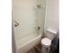 Bathroom featuring a shower over tub with a glass door and modern fixtures at 6662 Witherington Ct, Norcross, GA 30093