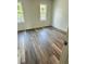 Bedroom featuring wood-look flooring and two windows for plenty of natural light at 6662 Witherington Ct, Norcross, GA 30093