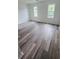 Spacious bedroom with new flooring and two windows offering natural light at 6662 Witherington Ct, Norcross, GA 30093