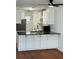 Modern kitchen features white cabinets, dark countertops, and stainless steel appliances at 6662 Witherington Ct, Norcross, GA 30093