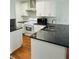 Modern kitchen has a kitchen island and stainless steel appliances at 6662 Witherington Ct, Norcross, GA 30093