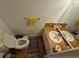 Cozy bathroom featuring a toilet, sink with a mirror, and a towel rack above the toilet at 964 Glynn Oaks Dr, Clarkston, GA 30021
