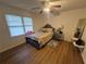 Well-lit bedroom with wood-look flooring, a comfortable bed, and stylish bedside table at 964 Glynn Oaks Dr, Clarkston, GA 30021