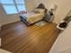 Well-lit bedroom with wood-look flooring, a comfortable bed, and stylish bedside table at 964 Glynn Oaks Dr, Clarkston, GA 30021
