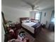 Bright bedroom featuring a ceiling fan, wood-look floors, and cozy furnishings at 964 Glynn Oaks Dr, Clarkston, GA 30021