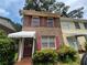 Charming two-story brick home with red shutters, showcasing its curb appeal and inviting entrance at 964 Glynn Oaks Dr, Clarkston, GA 30021