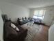 Inviting living room with hardwood floors, a modern rug, and comfortable seating arrangement at 964 Glynn Oaks Dr, Clarkston, GA 30021