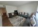 Inviting living room with hardwood floors, a modern rug, and comfortable seating arrangement at 964 Glynn Oaks Dr, Clarkston, GA 30021