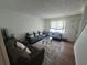 Inviting living room with hardwood floors, a modern rug, and comfortable seating arrangement at 964 Glynn Oaks Dr, Clarkston, GA 30021