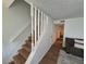 Bright staircase with hardwood steps and white railing leading to the upper level of the home at 964 Glynn Oaks Dr, Clarkston, GA 30021