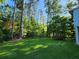Expansive backyard with a well-manicured lawn and surrounded by tall trees at 3054 Whisper Knob Rd, Marietta, GA 30062