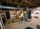 Unfinished basement with exposed ceiling, water heater, shelving, and stairway at 3054 Whisper Knob Rd, Marietta, GA 30062