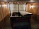 Basement with hot tub, wood paneled walls, and tiled floor at 3054 Whisper Knob Rd, Marietta, GA 30062