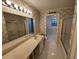 Bathroom with patterned wallpaper, a large mirror, and a walk-in tub at 3054 Whisper Knob Rd, Marietta, GA 30062