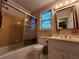 Bathroom with tub, shower, sink, mirror, wallpaper, vanity, and tiled walls at 3054 Whisper Knob Rd, Marietta, GA 30062