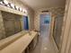 Bathroom featuring patterned wallpaper, a vanity, and a tub with a shower at 3054 Whisper Knob Rd, Marietta, GA 30062