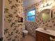 Charming half-bathroom with patterned wallpaper, a window, and a classic vanity at 3054 Whisper Knob Rd, Marietta, GA 30062