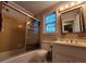 Bathroom featuring a shower, vanity, toilet, and natural light from the window at 3054 Whisper Knob Rd, Marietta, GA 30062