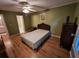 Bedroom featuring wood-look floors, a ceiling fan, and a floral print at 3054 Whisper Knob Rd, Marietta, GA 30062